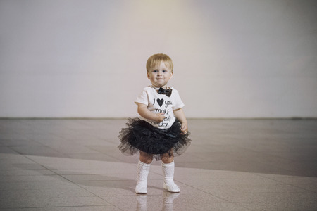 Baby girl little very trendy and stylish dressed beautiful cute and happy in the roomの写真素材