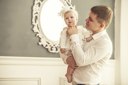 Family, father and daughter together at home cuddling beautiful and happy close-upの写真素材