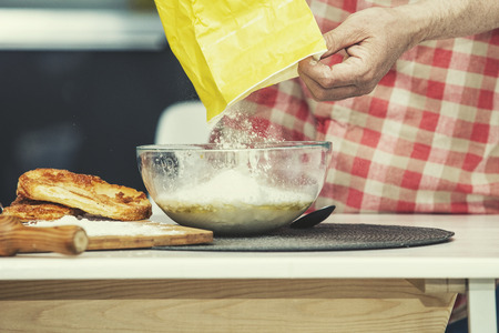 Hands closeup of a chef who makes the dough in the kitchen on the tableの写真素材