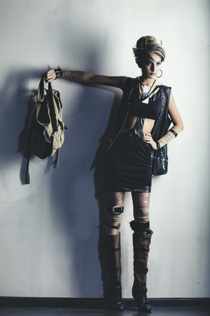 Woman beautiful model with body art on the face of unusual and fashionable clothing in the Studioの写真素材