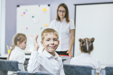 Beautiful children are students together in a classroom in school get the education with the teacherの写真素材