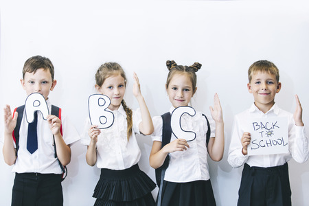 Beautiful children are students together in a class at school on white background boards are receiving education happyの写真素材