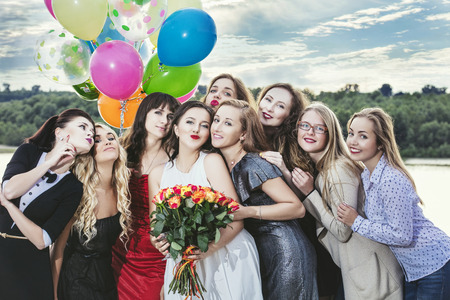 Young beautiful happy women celebrate bachelorette party at the pier