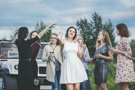 Young beautiful happy women celebrate bachelorette party in a convertible limousineの写真素材