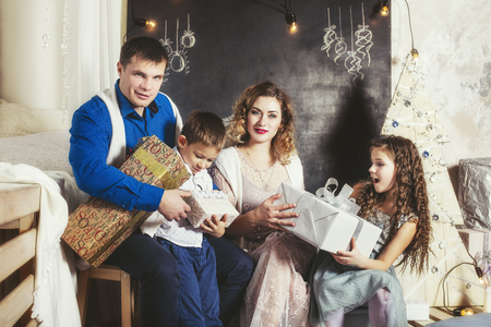 Family, dad, mom and kids happy with beautiful smiles to celebrate Christmas together at homeの写真素材