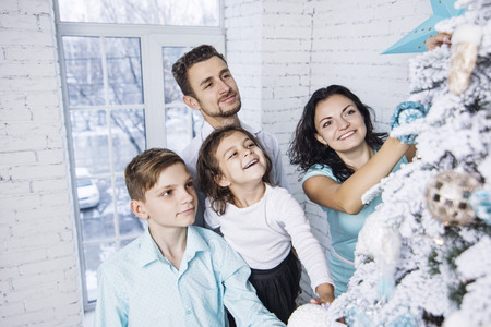 Beautiful happy family mother, father, son, and daughter to celebrate Christmas and new year...