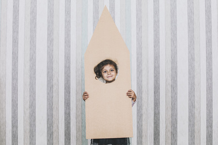 Child little girls playing spaceman with a cardboard rocketの写真素材