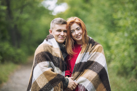 Young adult beautiful couple in love man and woman walking together in nature in the Park happy and beautifulの写真素材