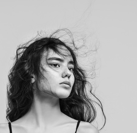 Young beautiful girl model Asian brunette with long hair posing in Studio on isolated backgroundの写真素材