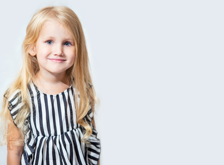 Little child girl beautiful fashionable and happy on isolated backgroundの写真素材