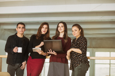 Young people do business or organize a startup together communicating in a loft-style roomの写真素材