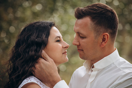Beautiful happy couple in love man and woman, portrait in nature close-upの写真素材
