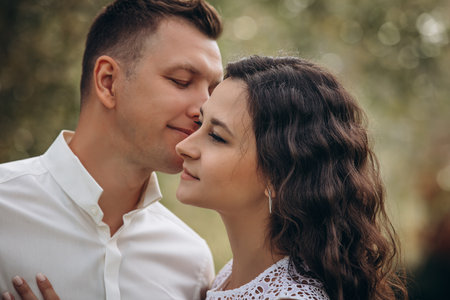 Beautiful happy couple in love man and woman, portrait in nature close-upの写真素材