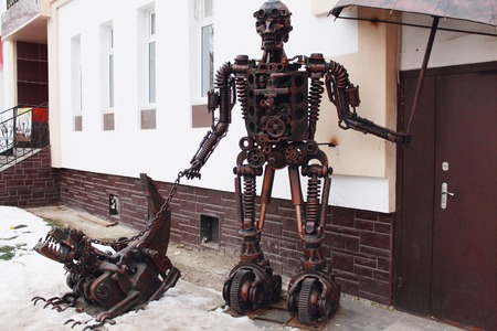 sculpture of a man and a dog made of parts for carsの写真素材