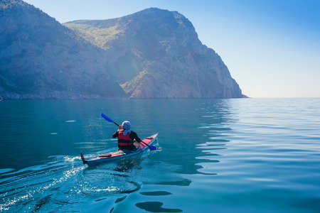 Kayak. People kayaking in the sea. Leisure activities on the calm blue water.