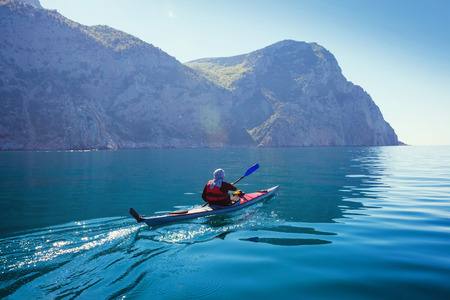 Kayak. People kayaking in the sea with calm blue water.の写真素材