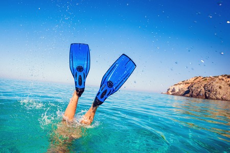Flippers in water. Diver fins. Active vacation at sea. Diving.の写真素材