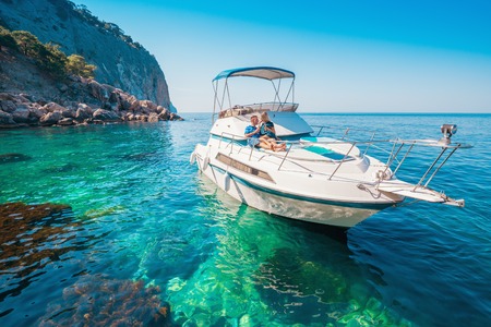 Couple on a Boat. Luxury vacation on the Yacht young man and woman. Sailing the Sea.の写真素材