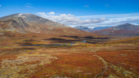 Sunny and cloudy the Muorki valley in autumn, Kungsleden trail, Sweden