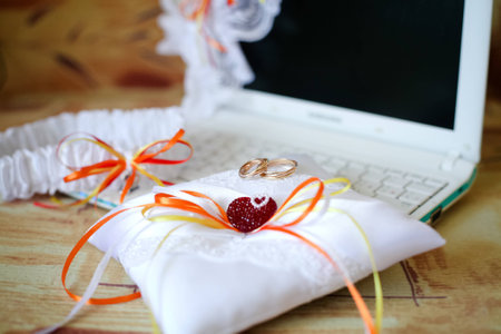 Wedding wedding rings on white pillow with a notebook 1の写真素材