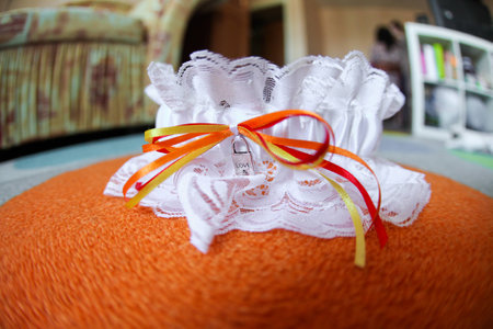 Wedding garter white with padlock and ribbons yellow, red 1の写真素材