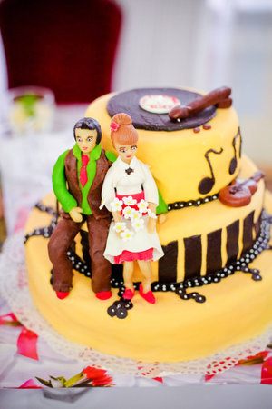 Yellow wedding cake figures of a bride and groom 1の写真素材
