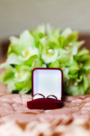 Wedding rings in red box on the green bouquet 1の写真素材