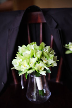 Wedding bouquet in green vase on the chair 1の写真素材