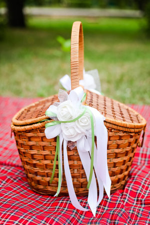 Basket with white decorations on red plaid 1の写真素材