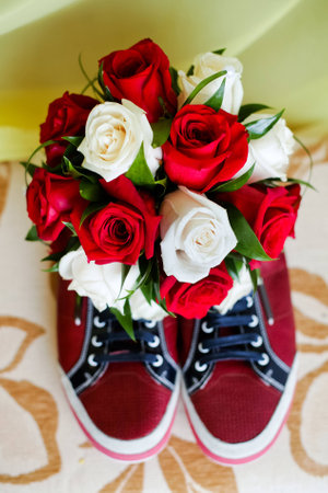 Red shoes on a brown floor with  bouquet of roses 1の写真素材