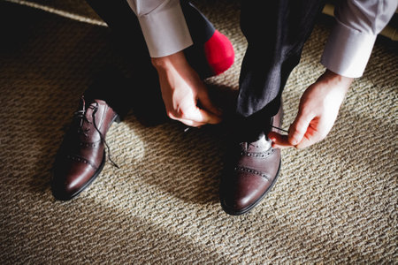 The groom wears black shoes in the hotel 1の写真素材