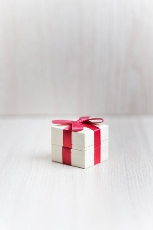 Box for rings with a red ribbon on the table 1