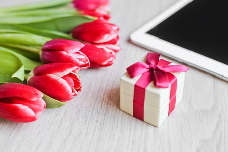 Red tulips, gift box with a red bow and  tablet 1の写真素材