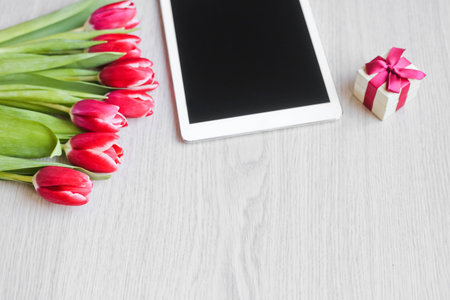 Red tulips, gift box with a red bow and  tablet 1の写真素材