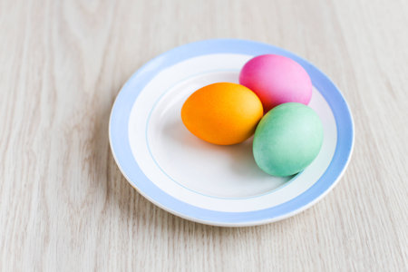 Easter eggs on a table in the plateの写真素材