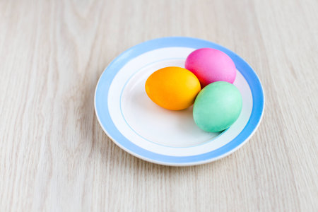 Easter eggs on a white table in the plate 1の写真素材