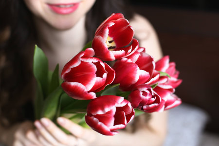 Girl with flowers red and white, tulips 1の写真素材