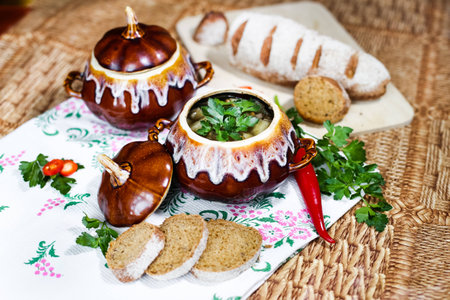 Pot of soup potato and parsley on the table