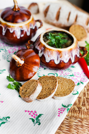 Pot of soup potato and parsley on the tableの写真素材