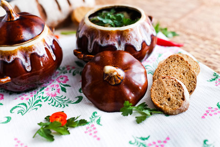 Pot of soup potato and parsley on the tableの写真素材