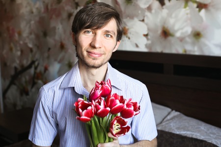 Women's day, the guy with the red tulipsの写真素材