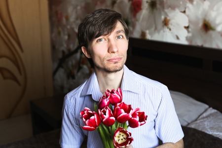 Women's day, the guy with red tulipsの写真素材