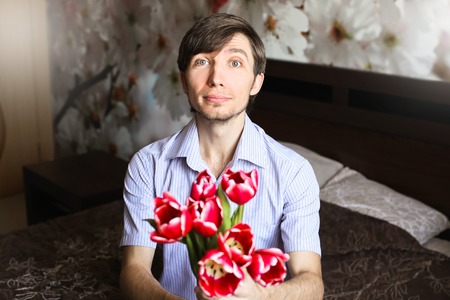 Women's day, the guy with red tulipsの写真素材