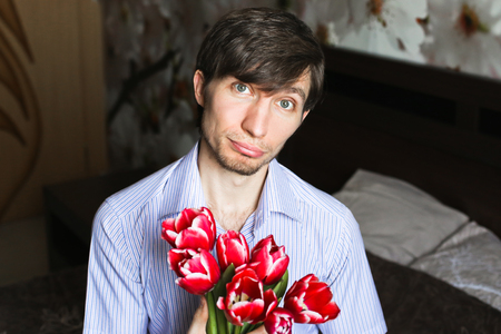 Women's day, the guy with red tulipsの写真素材