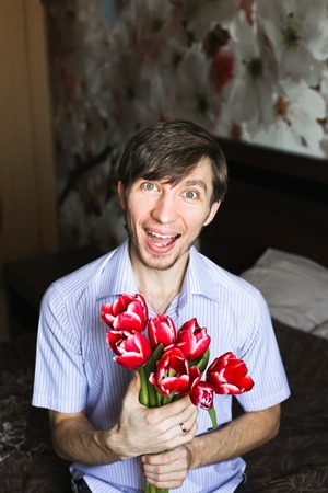 Women's day, the guy with red tulipsの写真素材