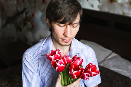 Women's day, the guy with red tulipsの写真素材