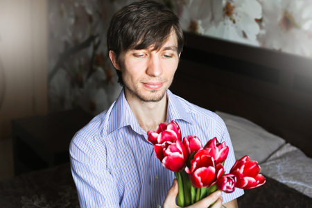 Women's day, the guy with red tulipsの写真素材