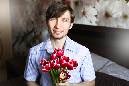 Women's day, the guy with red tulipsの写真素材