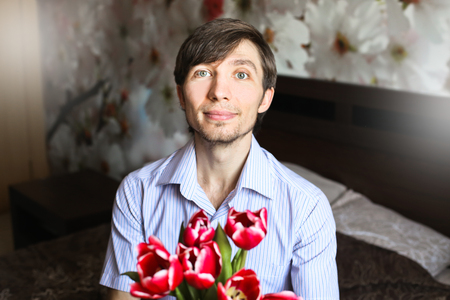 Women's day, the guy with red tulipsの写真素材