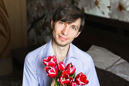 Women's day, the guy with red tulipsの写真素材